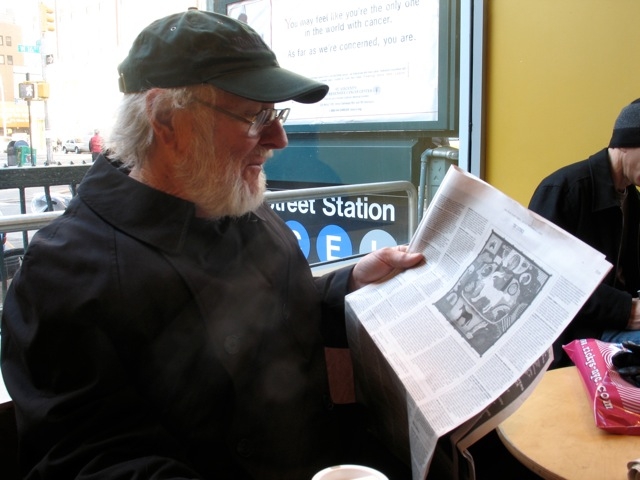 Roy De Forest reading the review of his 2005 solo exhibition in the&nbsp;New York Times,&nbsp;New York, December 2, 2005.